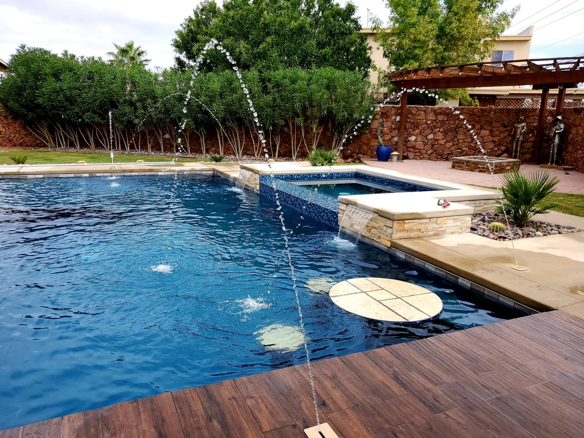 Custom Pizarro pool with integrated spa and landscaped outdoor living area